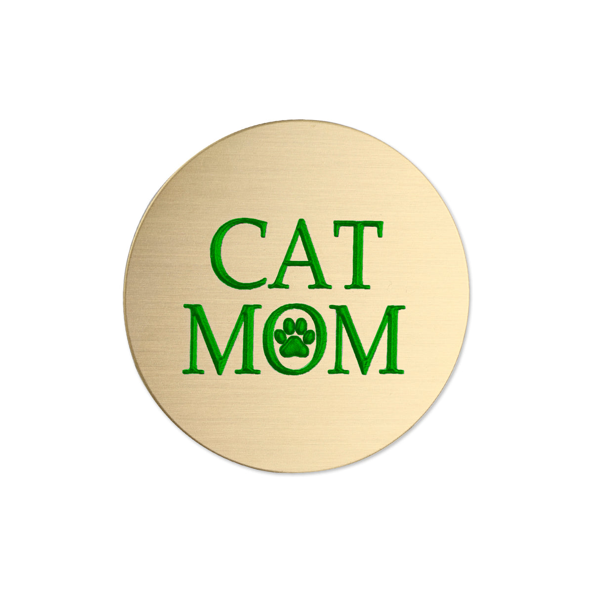 A round, brushed gold metal sticker featuring the text 'CAT MOM' in green, with the letter 'O' replaced by a green paw print icon, shown on a plain white background.