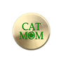 A round, brushed gold metal sticker featuring the text 'CAT MOM' in green, with the letter 'O' replaced by a green paw print icon, shown on a plain white background.
