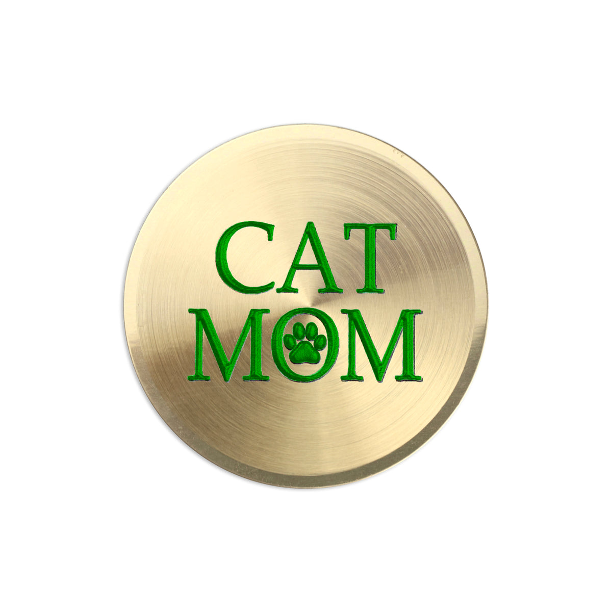 A round, brushed gold metal sticker featuring the text 'CAT MOM' in green, with the letter 'O' replaced by a green paw print icon, shown on a plain white background.
