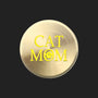 A round, brushed gold metal sticker featuring the text 'CAT MOM' in yellow, with the letter 'O' replaced by a small yellow paw print icon, shown on a plain white background.