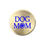 A round, brushed gold metal sticker  featuring the text 'DOG MOM' in bold blue lettering, with a blue paw print icon replacing the letter 'O'.