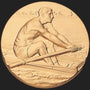 Metal Stickems 2-inch round adhesive gold metal disc featuring a detailed embossed rowing athlete design.