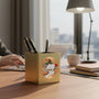 Metal Stickems academic achievement metal sticker featuring books, a quill, and a lamp on a gold desk organizer.