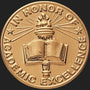 Metal Stickems 2-inch gold embossed sticker featuring an open book and torch for academic excellence awards.
