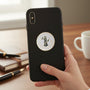 Metal Stickems 2-inch round Air National Guard metal emblem sticker applied to a black smartphone case