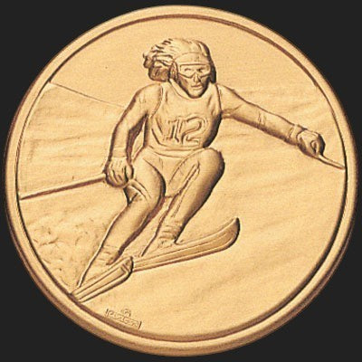 Metal Stickems 2-inch gold-toned adhesive metal sticker featuring an embossed alpine skier in motion.