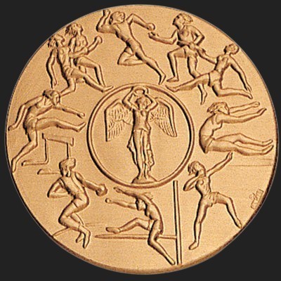 Metal Stickems 2-inch circular gold metallic sticker featuring embossed athletic figures and a winged victory emblem.