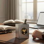 Metal Stickems Award of Excellence round metal sticker with gold handshake icon on a black background on a desk.