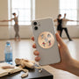 Metal Stickems ballet dancer themed round metal sticker on a smartphone case in a dance studio setting