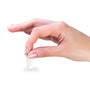 Metal Stickems 1 inch gold baseball emblem with embossed bat, glove, and diamond design held between fingers.