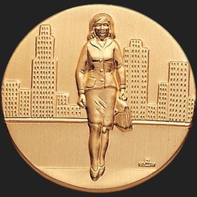 Metal Stickems round gold-tone adhesive sticker featuring an embossed businesswoman walking in front of a city skyline.