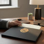 Metal Stickems round gold Congratulations sticker with handshake design on a black professional certificate folder