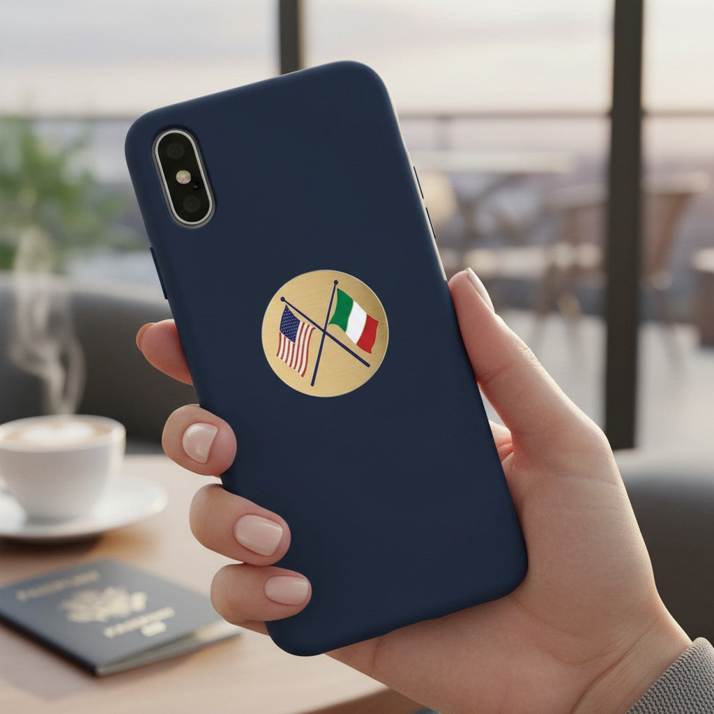 Metal Stickems round gold metal sticker with crossed American and Italian flags on a navy blue smartphone case.