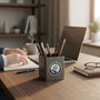 Metal Stickems Exceeding Expectations round metal sticker with star motif on a desk pen holder