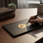 Metal Stickems 2-inch gold metallic Excellence In Leadership sticker applied to a black leather notebook on a desk.