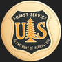 Metal Stickems 2-inch gold and black US Forest Service metal adhesive emblem with iconic pine tree shield design.