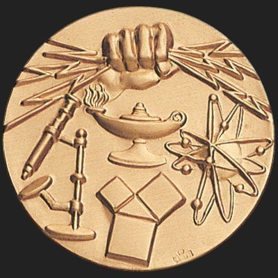 Metal Stickems 2-inch gold academic achievement sticker featuring embossed lamp of knowledge and scientific symbols.