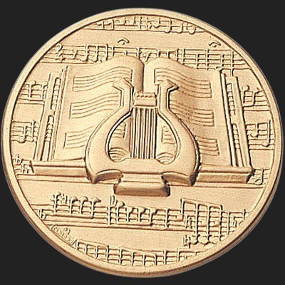Metal Stickems gold-toned metal adhesive sticker featuring an embossed lyre and musical notation design.