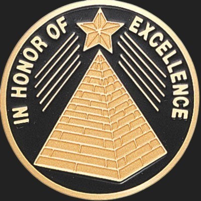 Metal Stickems 2-inch circular adhesive metal sticker with gold pyramid and star design on a black background.