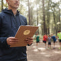 Metal Stickems 2-inch gold running medallion sticker applied to a clipboard held by a coach in a park.