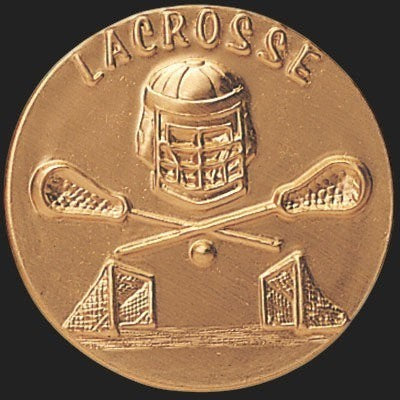 Metal Stickems 2-inch gold metal lacrosse sticker featuring an embossed helmet, crossed sticks, and goal design.