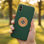 Metal Stickems 2-inch gold and blue Masonic Square and Compass metal emblem sticker applied to a green smartphone case.
