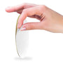 A hand peeling the backing off a 2-inch circular Metal Stickems Most Improved award sticker with a gold finish.