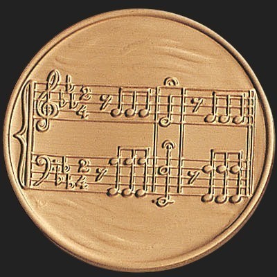 Metal Stickems round metal sticker featuring an embossed musical notation score in a polished bronze finish.