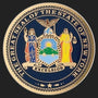 Metal Stickems 2-inch New York State Seal metal sticker with vibrant colors and Excelsior motto on a dark background.