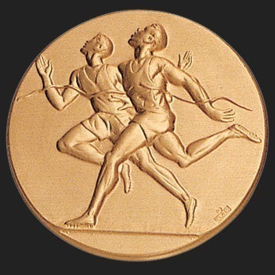 Metal Stickems 2-inch round gold adhesive disc featuring an embossed track and field runner design for awards.