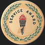 Metal Stickems 2-inch gold service award sticker featuring a torch and laurel wreath design for employee recognition.