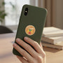 Metal Stickems Shriners decorative metal emblem sticker with scimitar and star design applied to a green smartphone case
