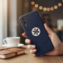 Metal Stickems 7/8 inch black and gold Star of Life metal emblem sticker applied to a navy blue smartphone case