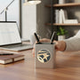 Metal Stickems 2-inch round Star Performer metal sticker applied to a brushed metal desk pen holder in an office.