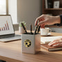 Metal Stickems 7/8 inch gold and black Star Performer metal sticker applied to a silver desk pen holder