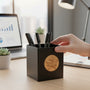 Metal Stickems 2 inch Star Performer adhesive metal sticker applied to a black desk pen holder in an office setting.