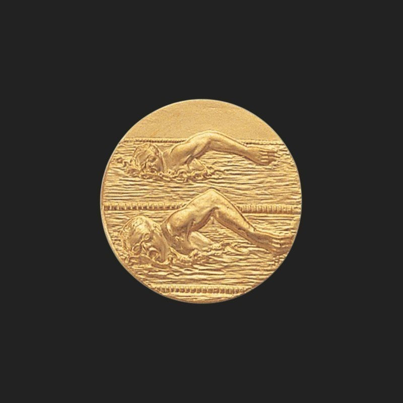 Metal Stickems 1-inch gold swimming competition award sticker featuring an embossed swimmer in a pool.