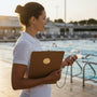 Metal Stickems swimming competition metal sticker on a clipboard held by a coach at a pool