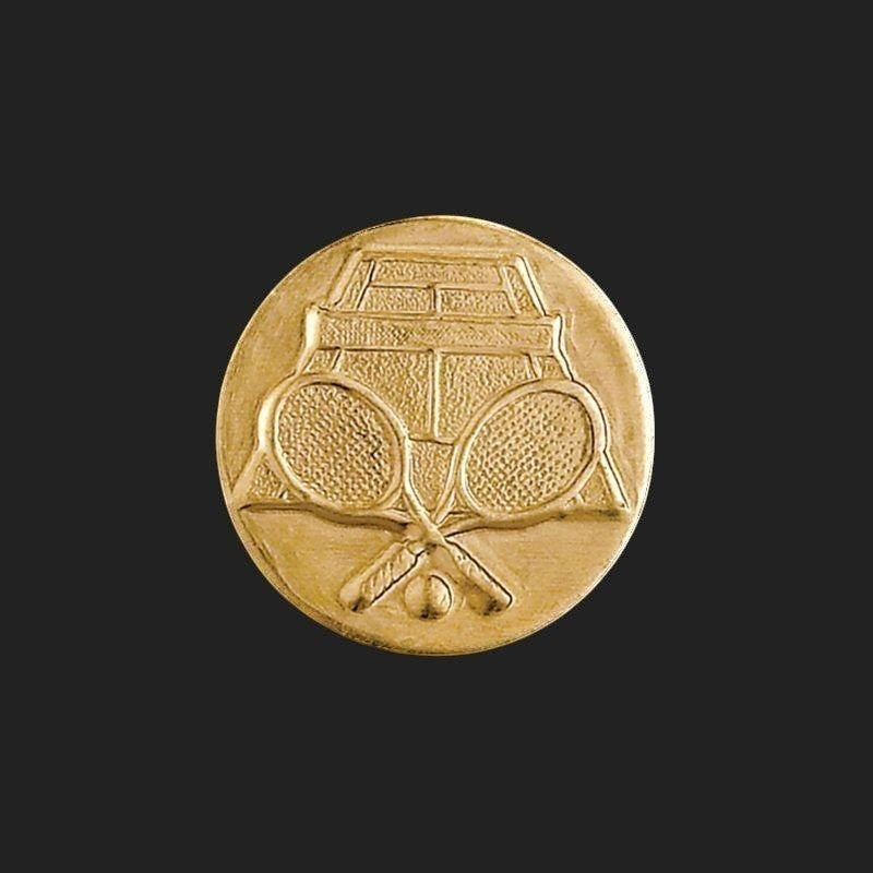 Metal Stickems 1-inch gold metal sticker featuring an embossed tennis court, crossed rackets, and a tennis ball.