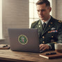 Metal Stickems 4-inch US Army metal emblem sticker on a laptop, with a soldier in uniform working at a desk.