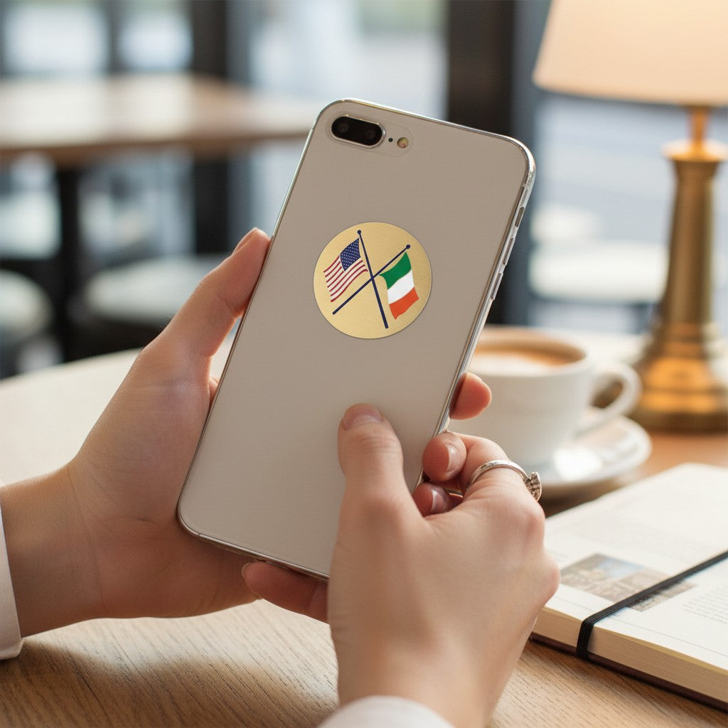 Metal Stickems 2-inch circular metal sticker with crossed US and Italy flags on a gold-tone background on a phone.