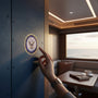 Metal Stickems 4-inch US Navy emblem sticker in blue and gold applied to a dark metal surface inside a cabin.