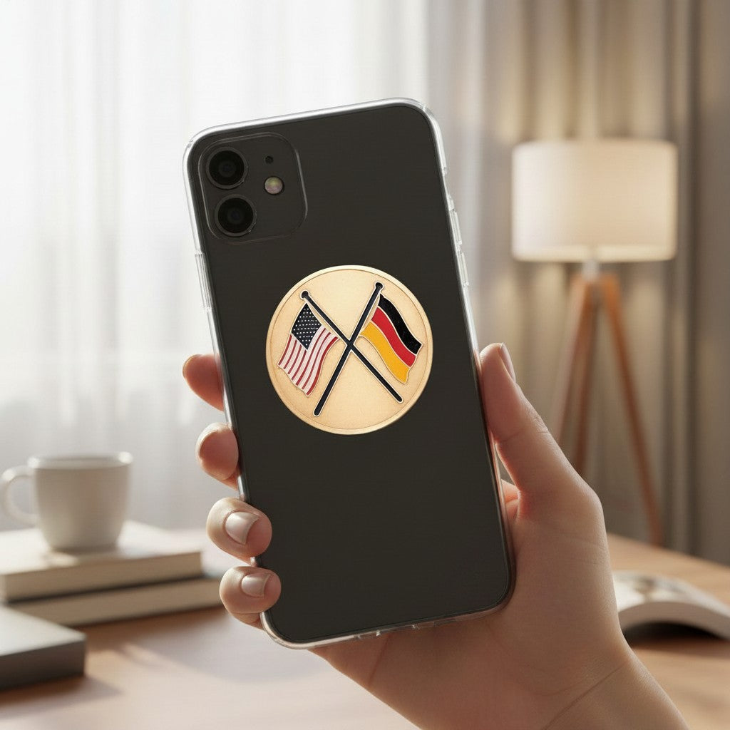 Metal Stickems 2-inch adhesive metal sticker featuring crossed USA and Germany flags on a black smartphone case.