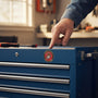 Metal Stickems 2-inch USMC Eagle Globe and Anchor metal sticker applied to a blue metal toolbox in a workshop.