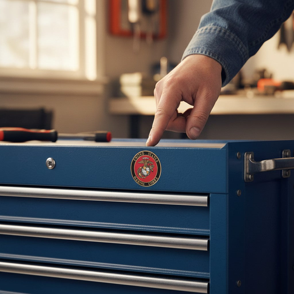 Metal Stickems 2-inch USMC Eagle Globe and Anchor metal sticker applied to a blue metal toolbox in a workshop.